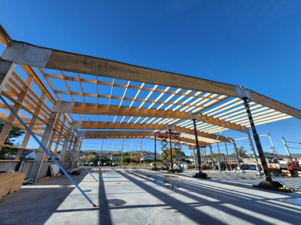 TimberSpan building under construction with structural beams on concrete pad