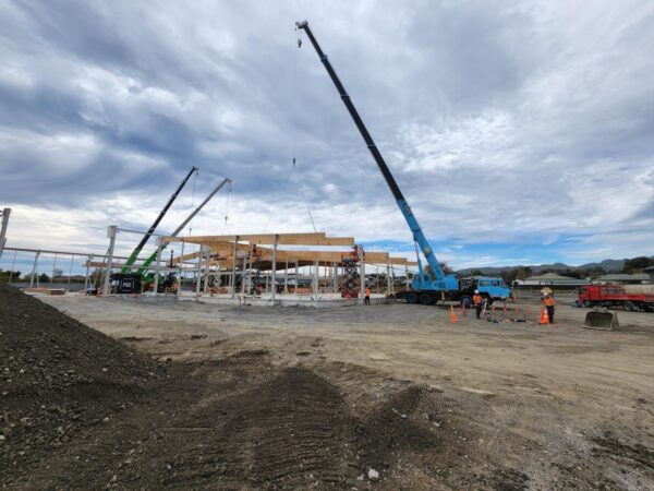 Large crane with TimberSpan beams being put into place on warehouse