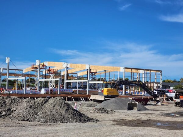 Image of construction workers securing TimberSpan Beams to hold roof