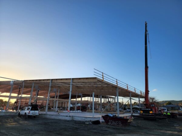 Early morning shot of TimberSpan building with roof and crane