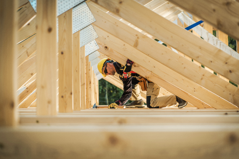 Builder framing up a roof