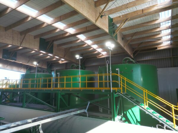 Angle image of inside of Permapine Treatment Plant with rafters and boilers